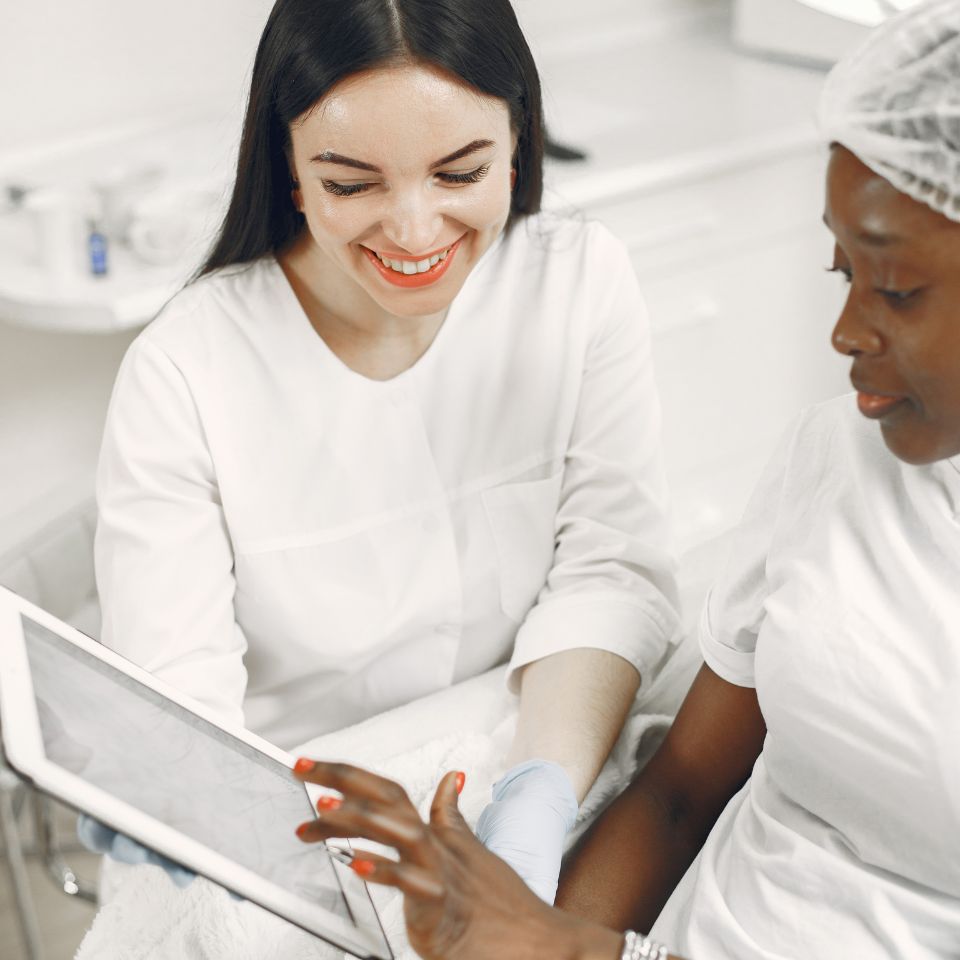 Clinician and client look at a small touch screen device